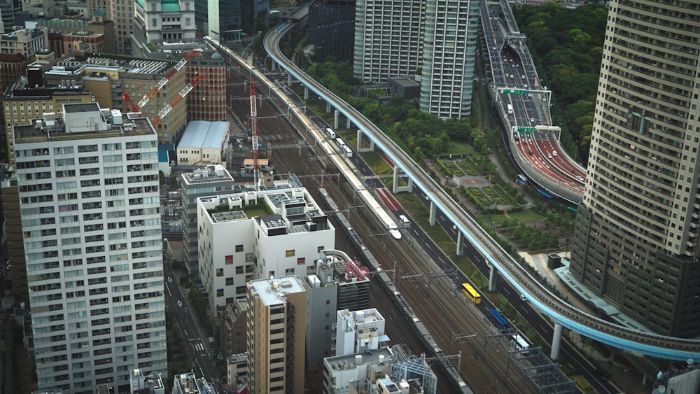 cars on road near high rise buildings during daytime