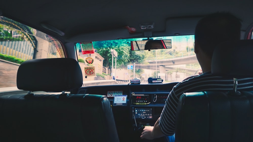 person in black and white striped long sleeve shirt driving car