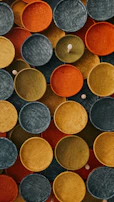 Colorful woven baskets arranged artistically on a natural fiber cloth.