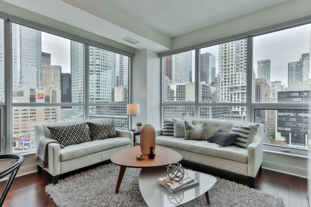 gray couch and brown wooden round table