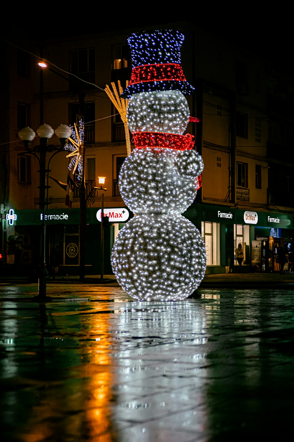 white and red christmas tree on the street during night time