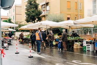 Local market street with colorful shops and fresh produce near the cabin.