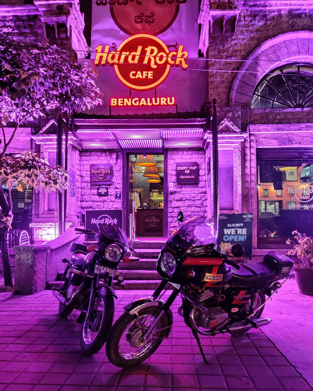black motorcycle parked beside purple building