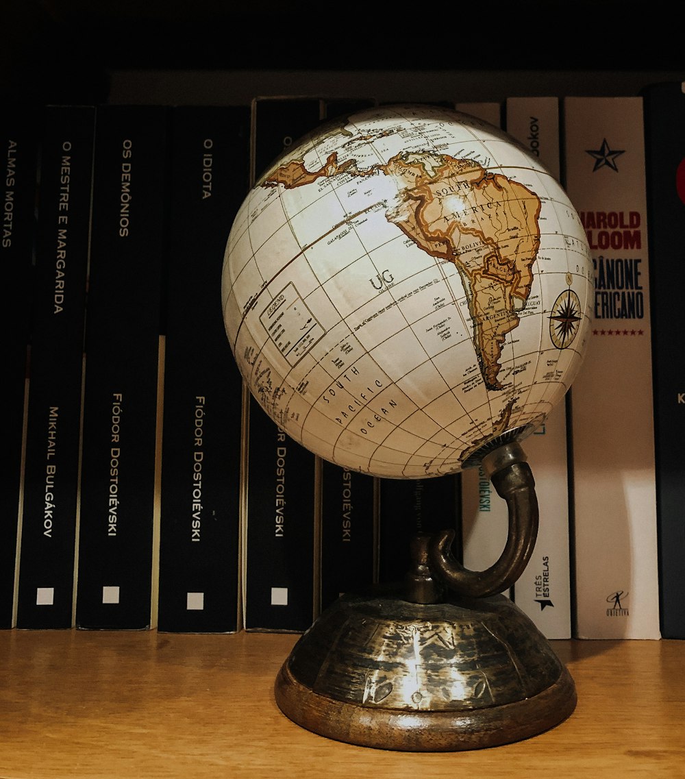white and brown desk globe on brown wooden table