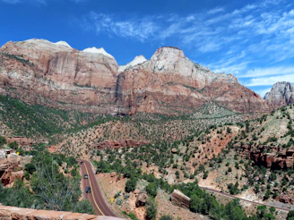 Traveler consulting a map with a backdrop of vibrant coral-colored cliffs
