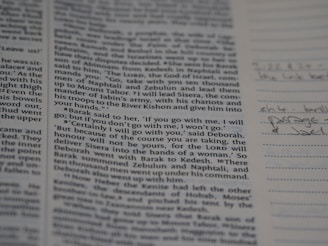 A page from a book with text in printed columns, discussing a biblical passage. There are handwritten notes on the right side in pen, adding personal annotations to the printed material.