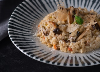 cooked rice with green vegetable on white round plate