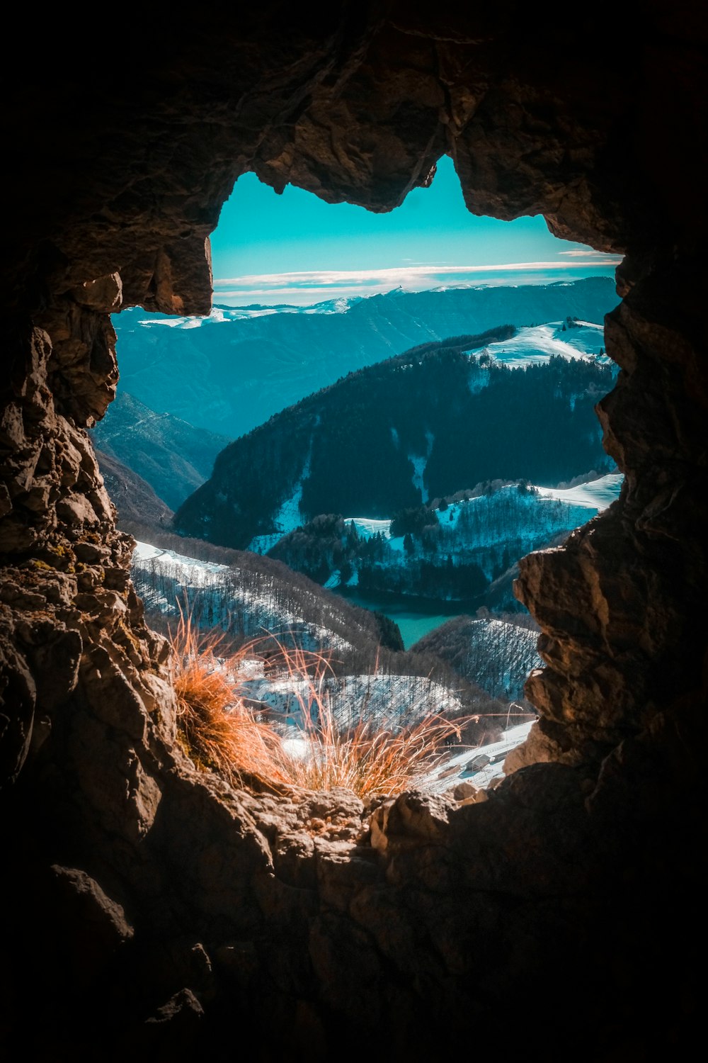 brown rocky mountain with snow