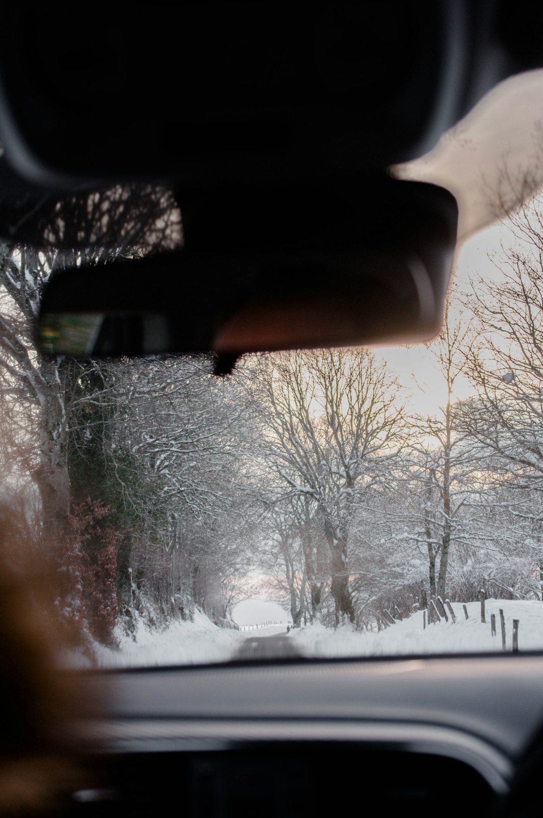 car window with snow on the road