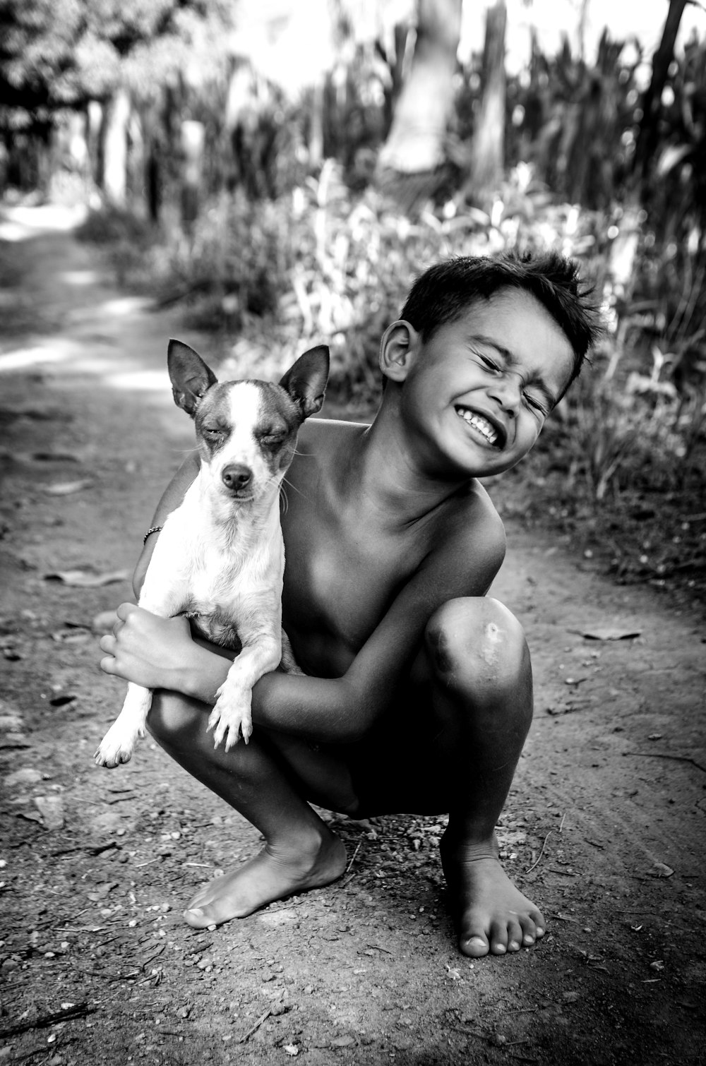 grayscale photo of woman carrying dog