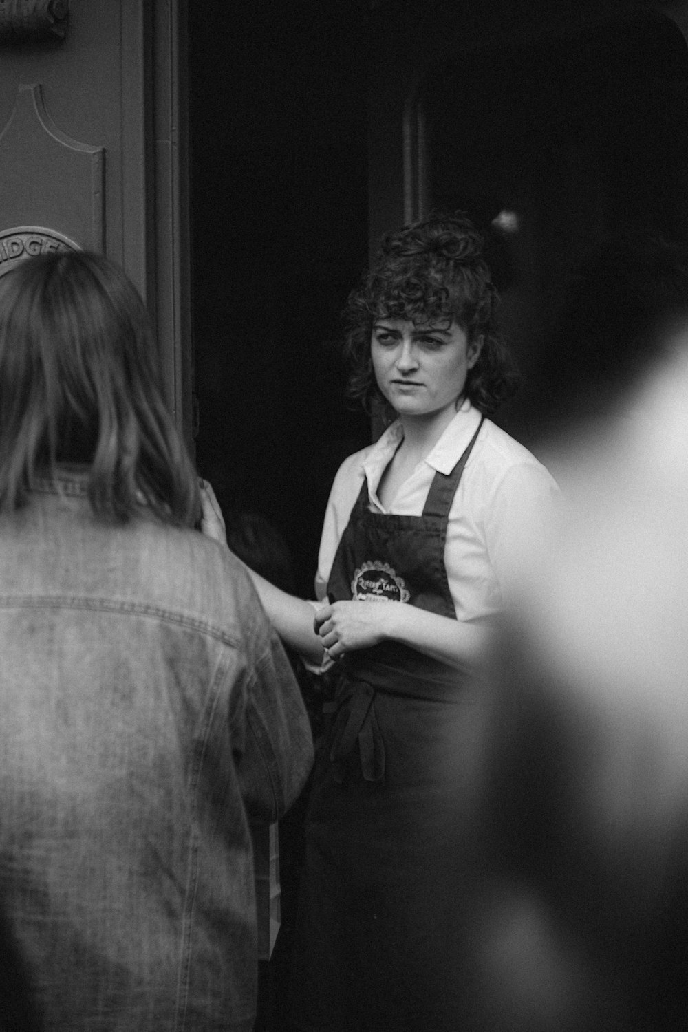 grayscale photo of woman in long sleeve shirt