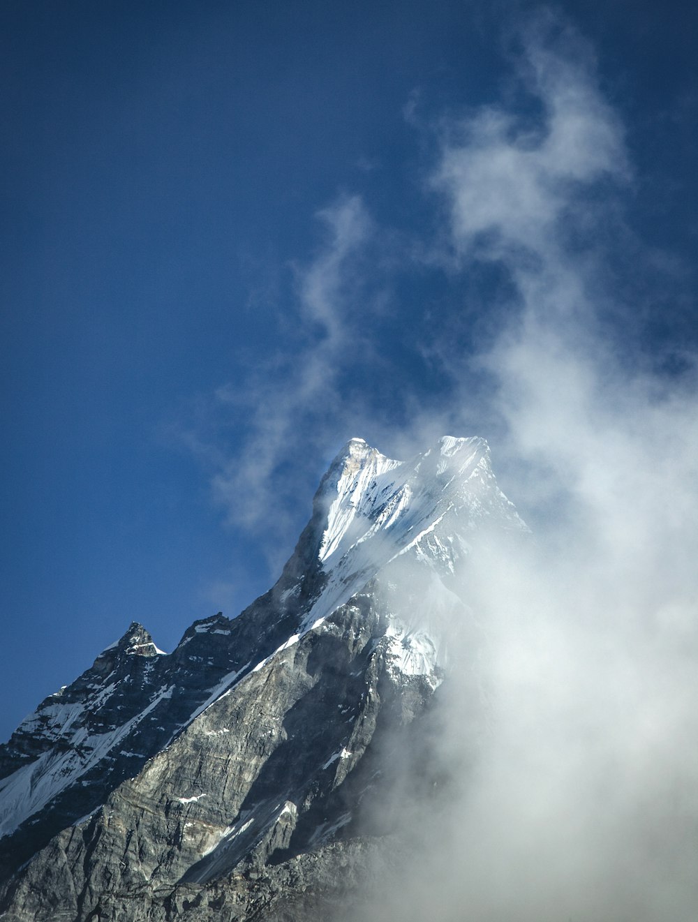 snow covered mountain under blue sky during daytime