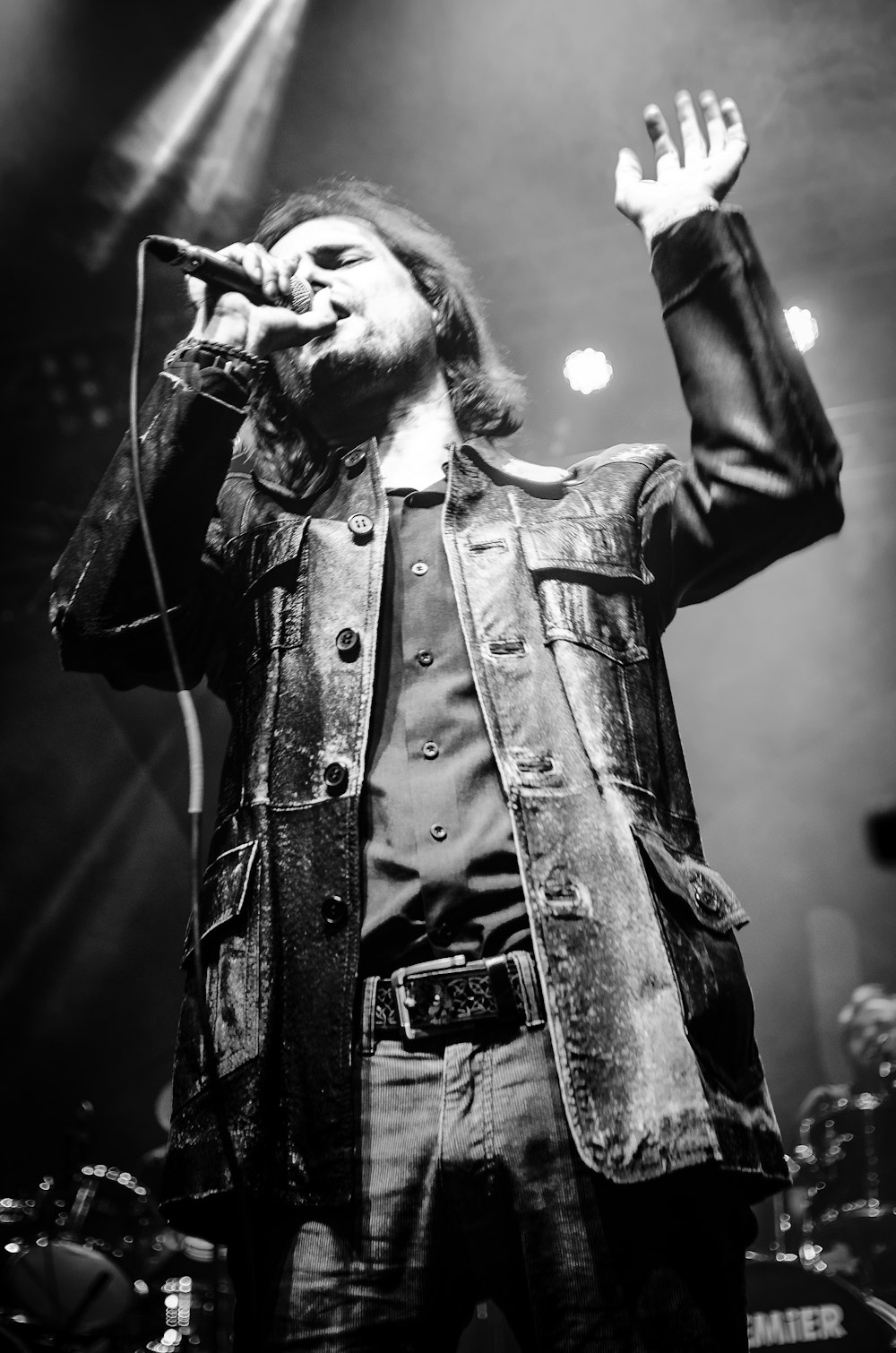 grayscale photo of man singing