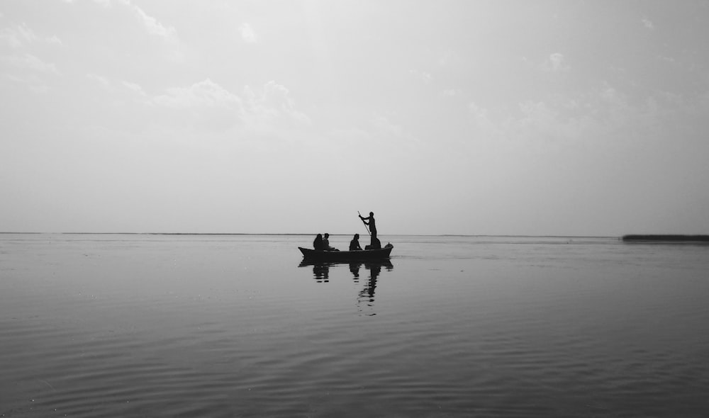 2 person riding on boat on body of water during daytime