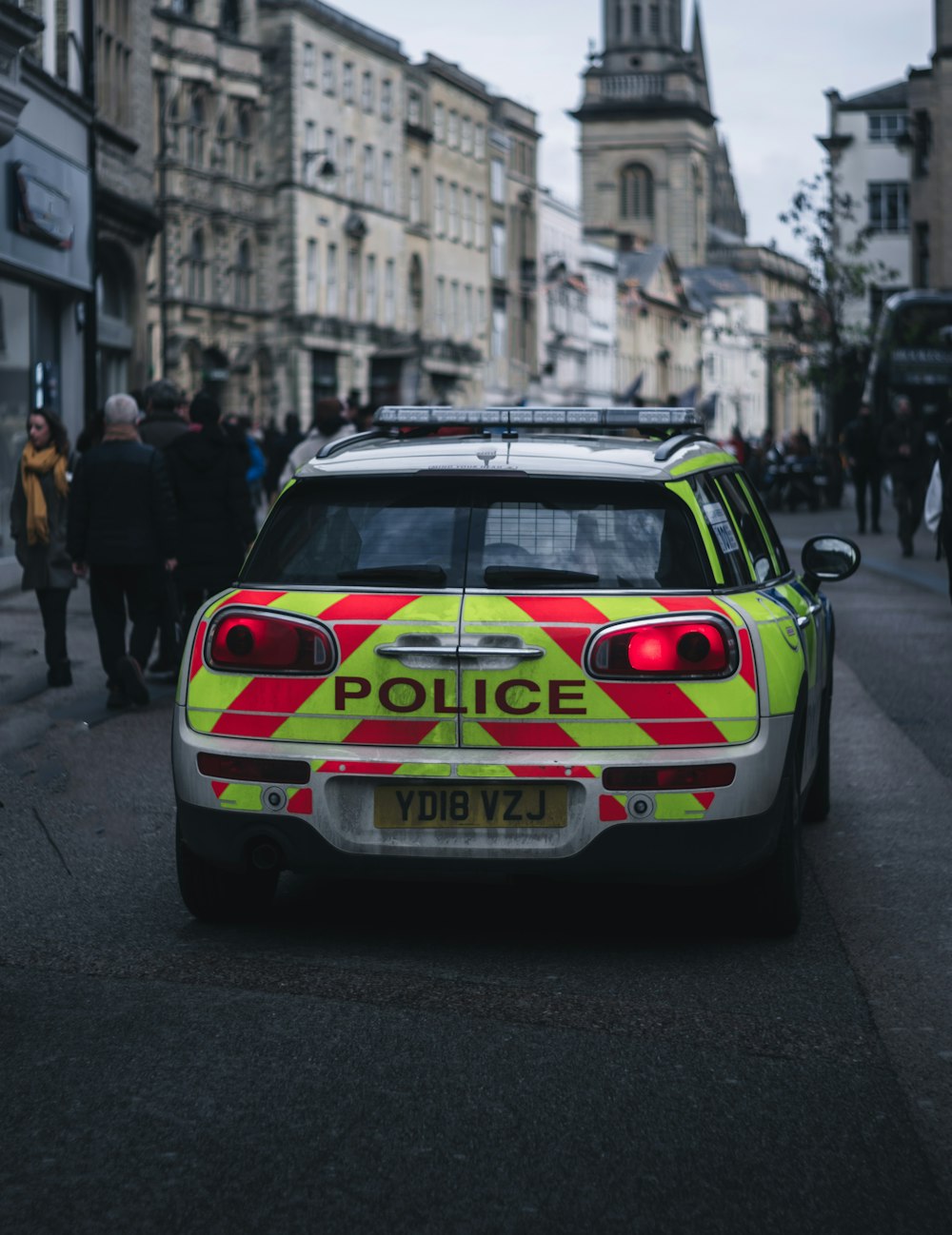 white and black police car on road during daytime