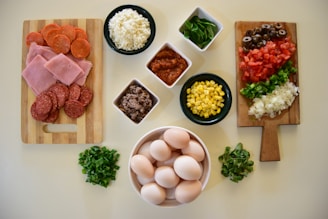 An assortment of colorful fresh ingredients used in pizza making.