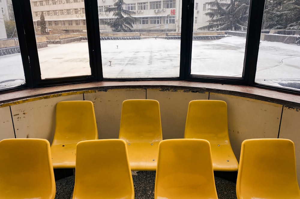 yellow chairs near glass window