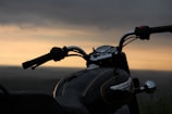 black motorcycle on the beach during sunset