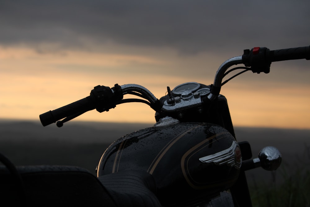 black motorcycle on the beach during sunset