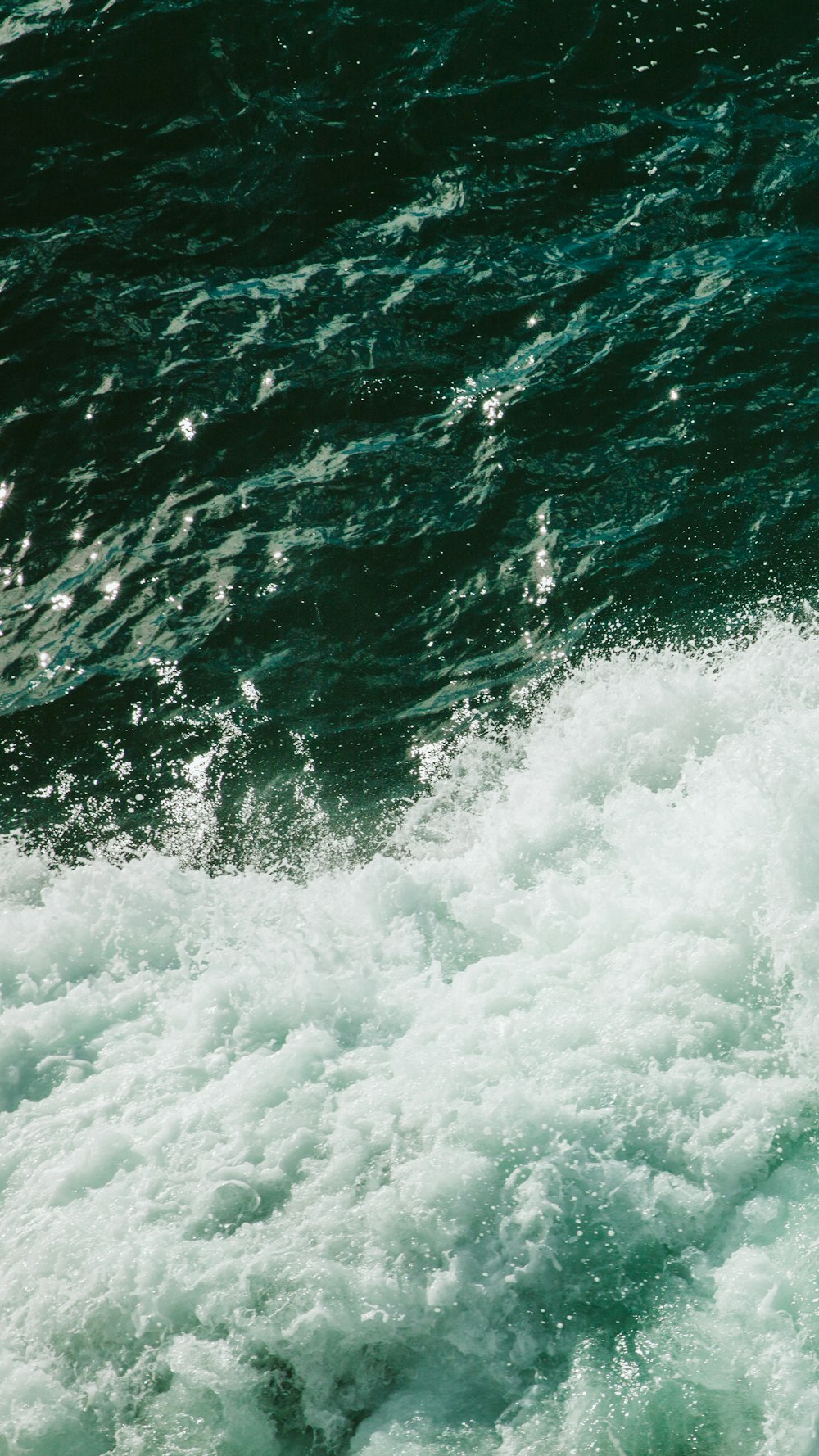 ocean waves crashing on shore during daytime