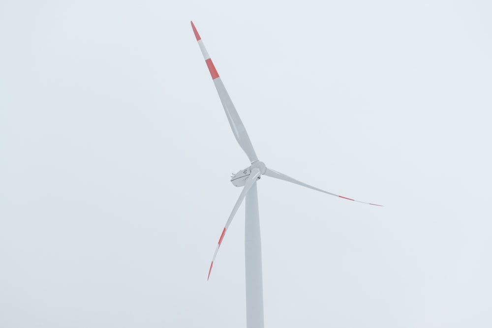 white and red windmill under white sky