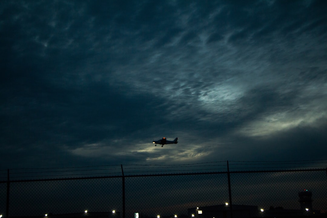 airplane flying over the city during night time