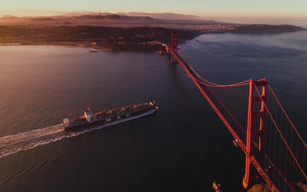 red bridge over body of water during daytime