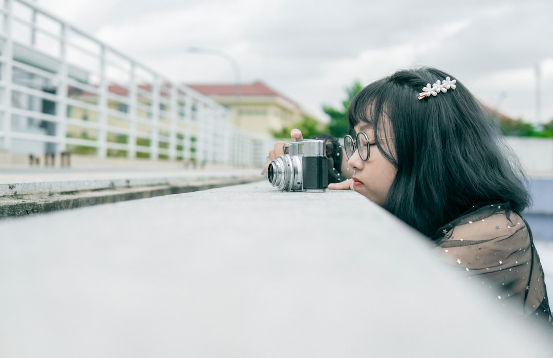 woman in black shirt holding black camera