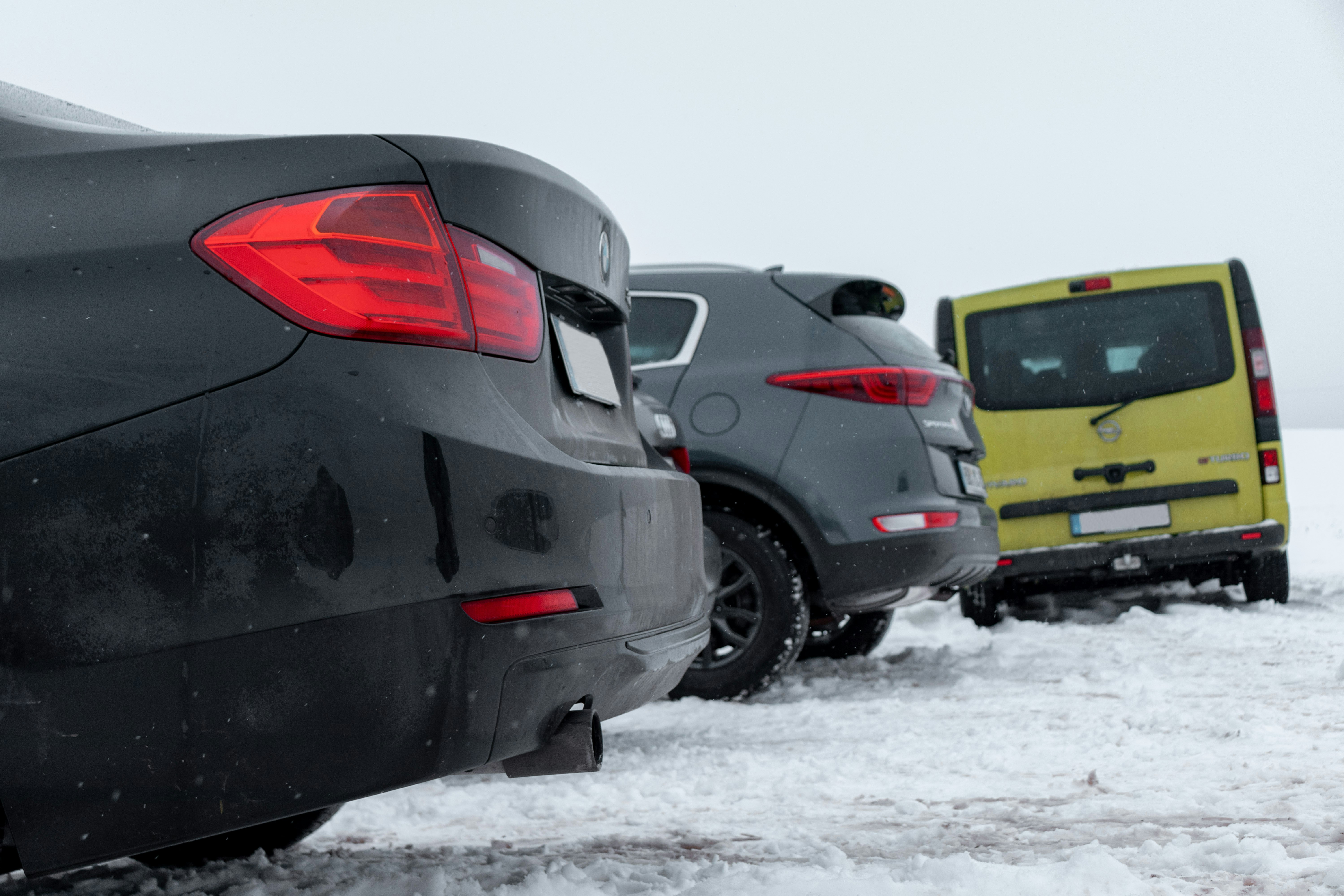 black and red car on snow covered ground