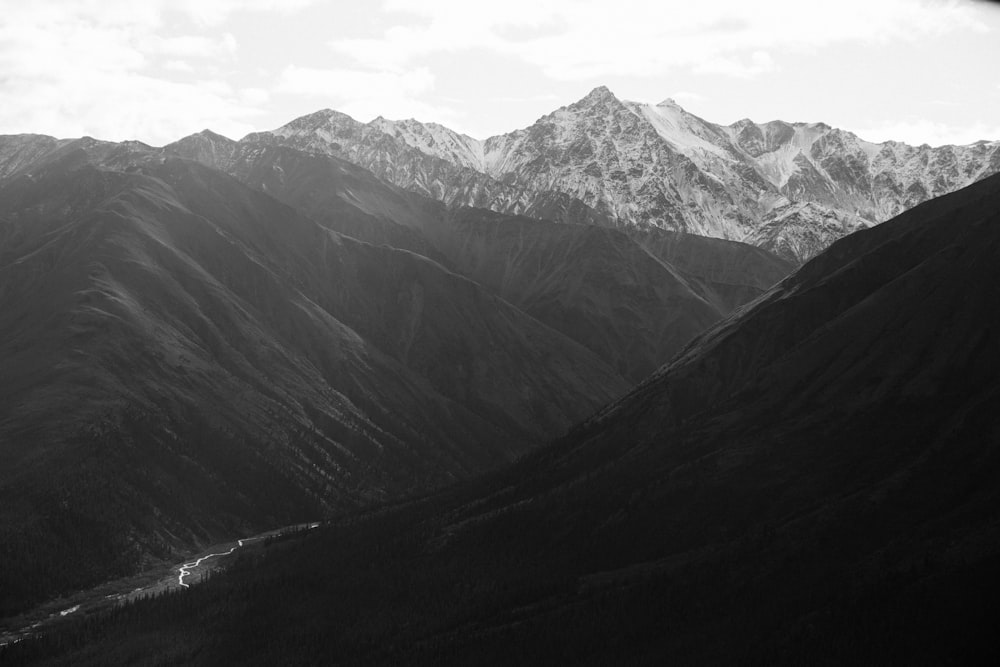 grayscale photo of mountains and river