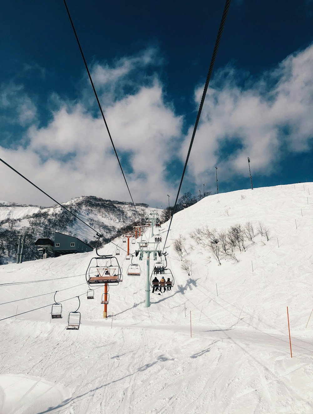 昼間の雪に覆われた山の上のケーブルカー