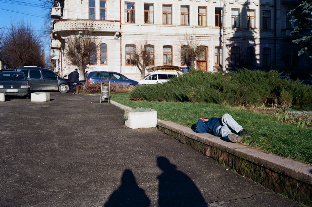 white and black cars parked near white concrete building during daytime