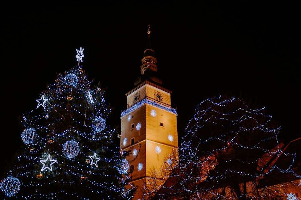 brown and black tower with lights during night time