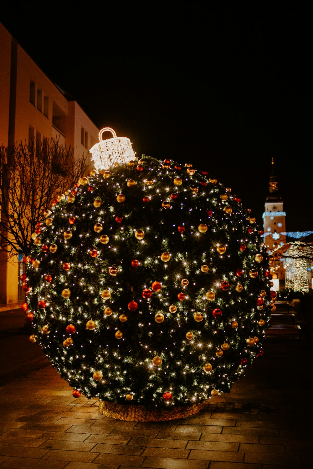 christmas tree with red baubles and string lights