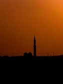 A serene mosque silhouette at sunset, symbolizing spiritual learning.