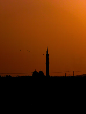 A serene mosque silhouette at sunset, symbolizing spiritual learning.