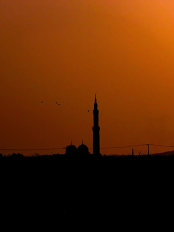 A serene mosque silhouette at sunset, highlighting peace and learning.