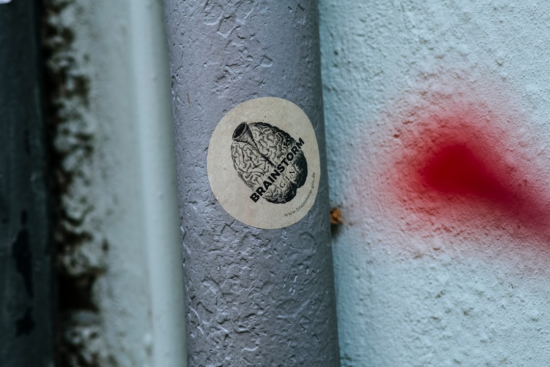 white and black heart shaped sticker on white metal pipe