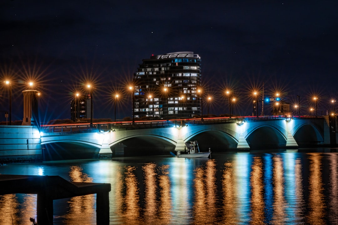 lighted bridge over river during night time