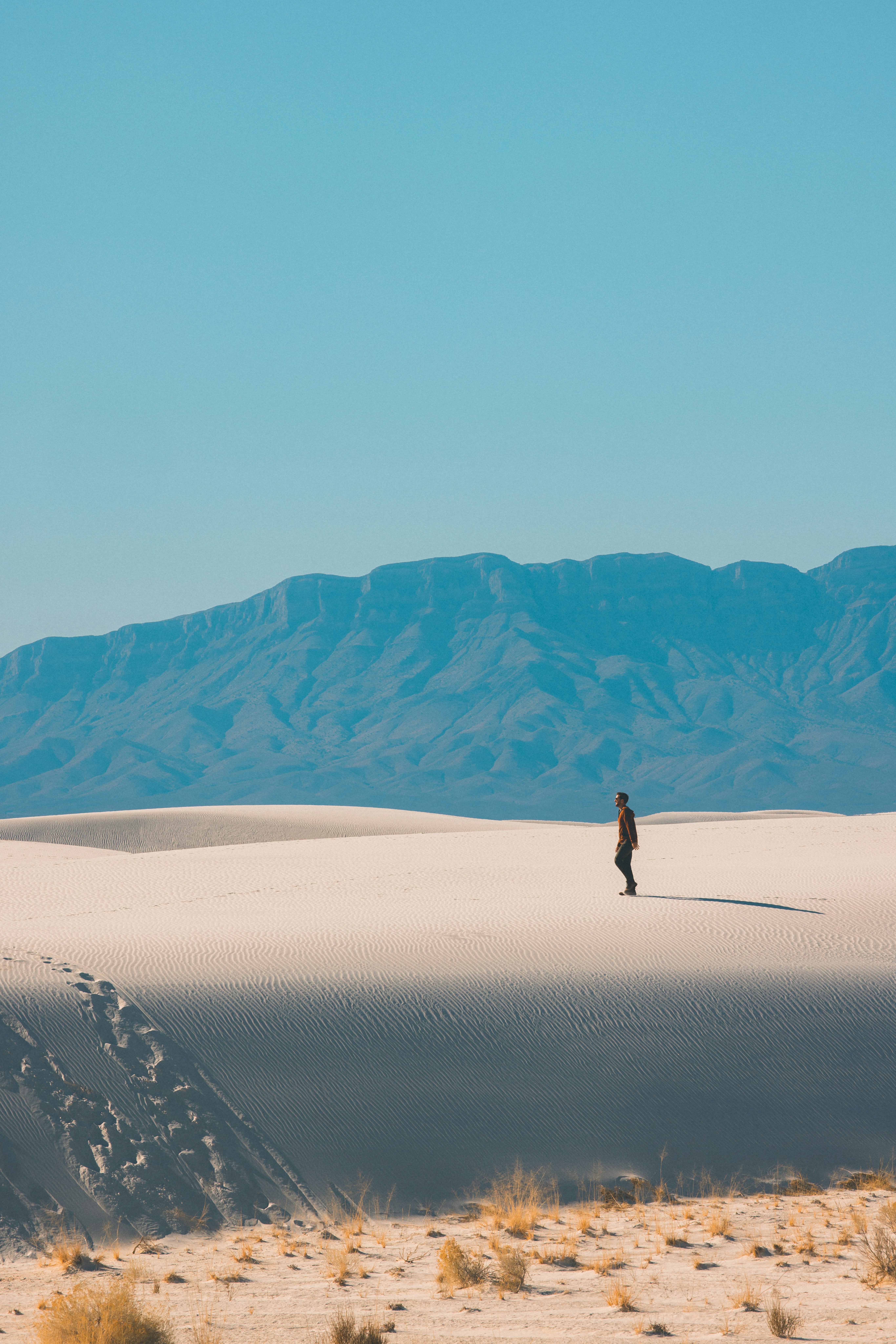 person walking on desert during daytime