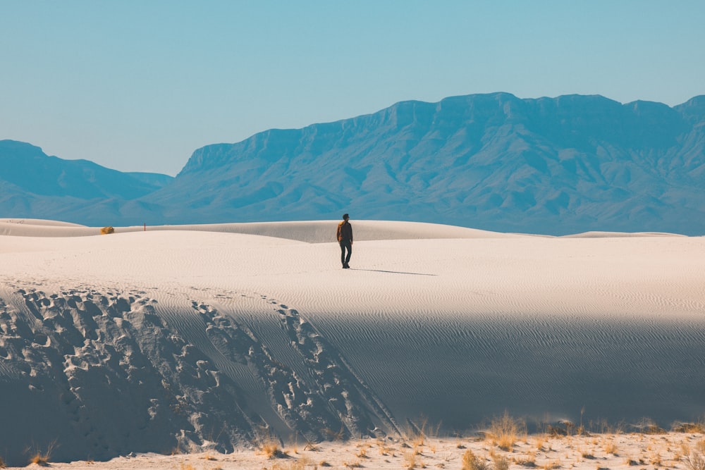 person walking on desert during daytime