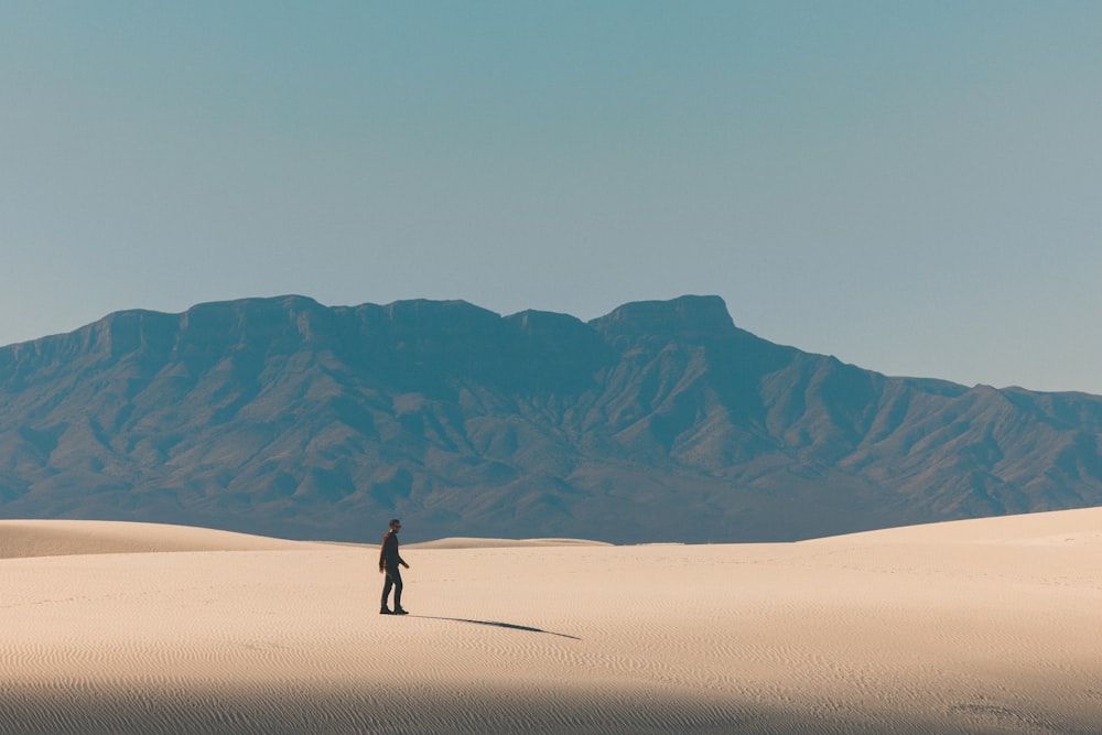 person walking on desert during daytime