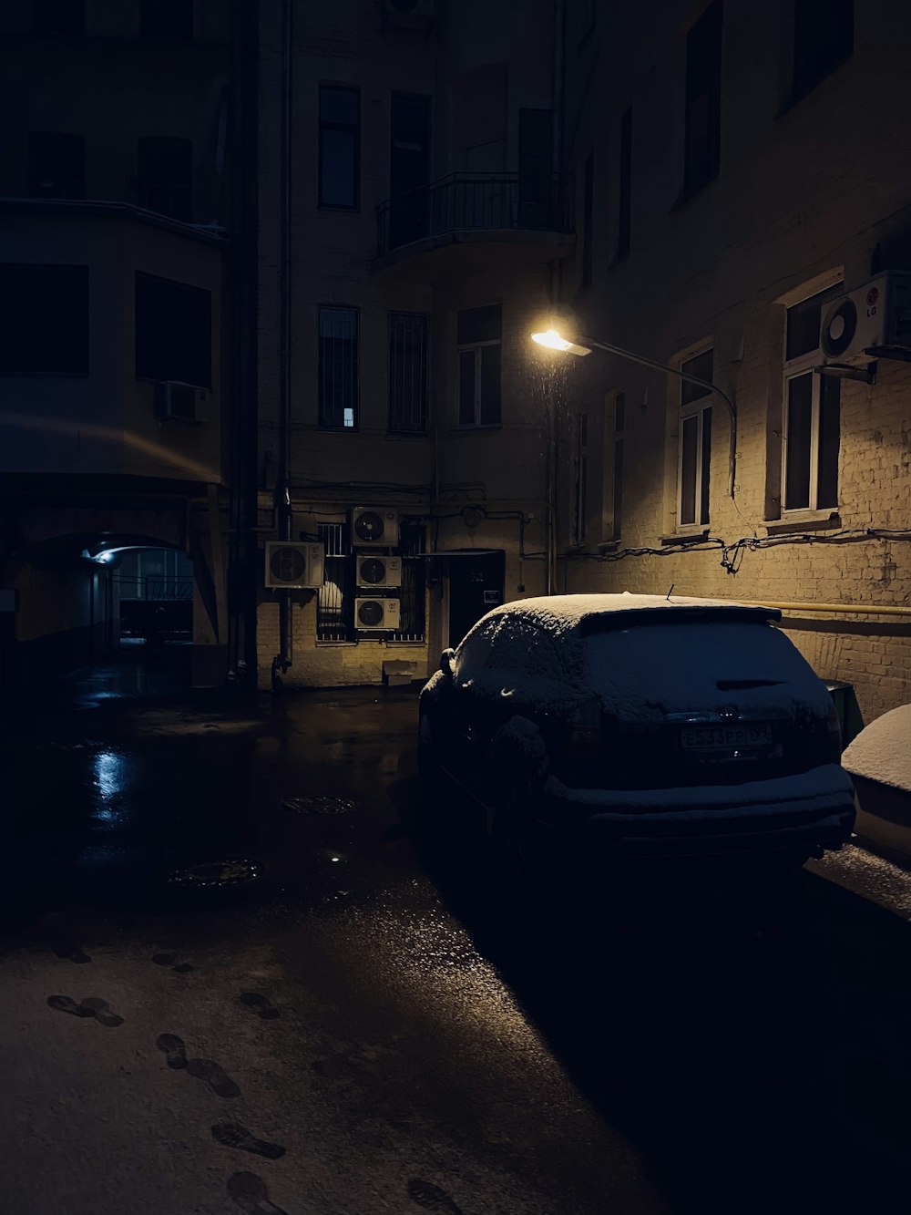 black car parked beside building during night time