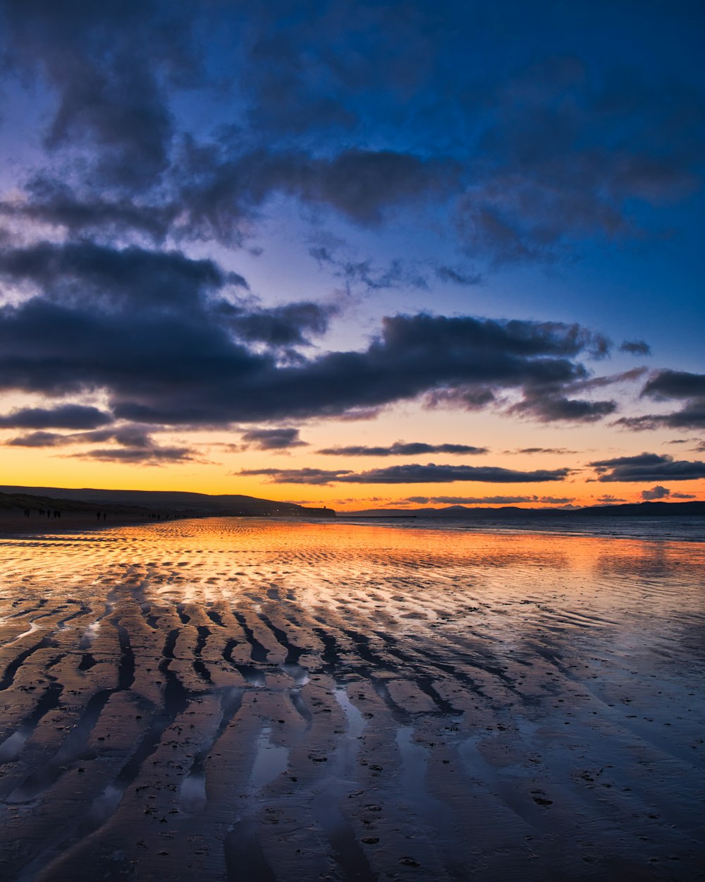 body of water under cloudy sky during daytime