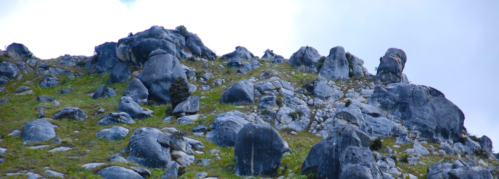 Montaña rocosa gris bajo el cielo blanco durante el día