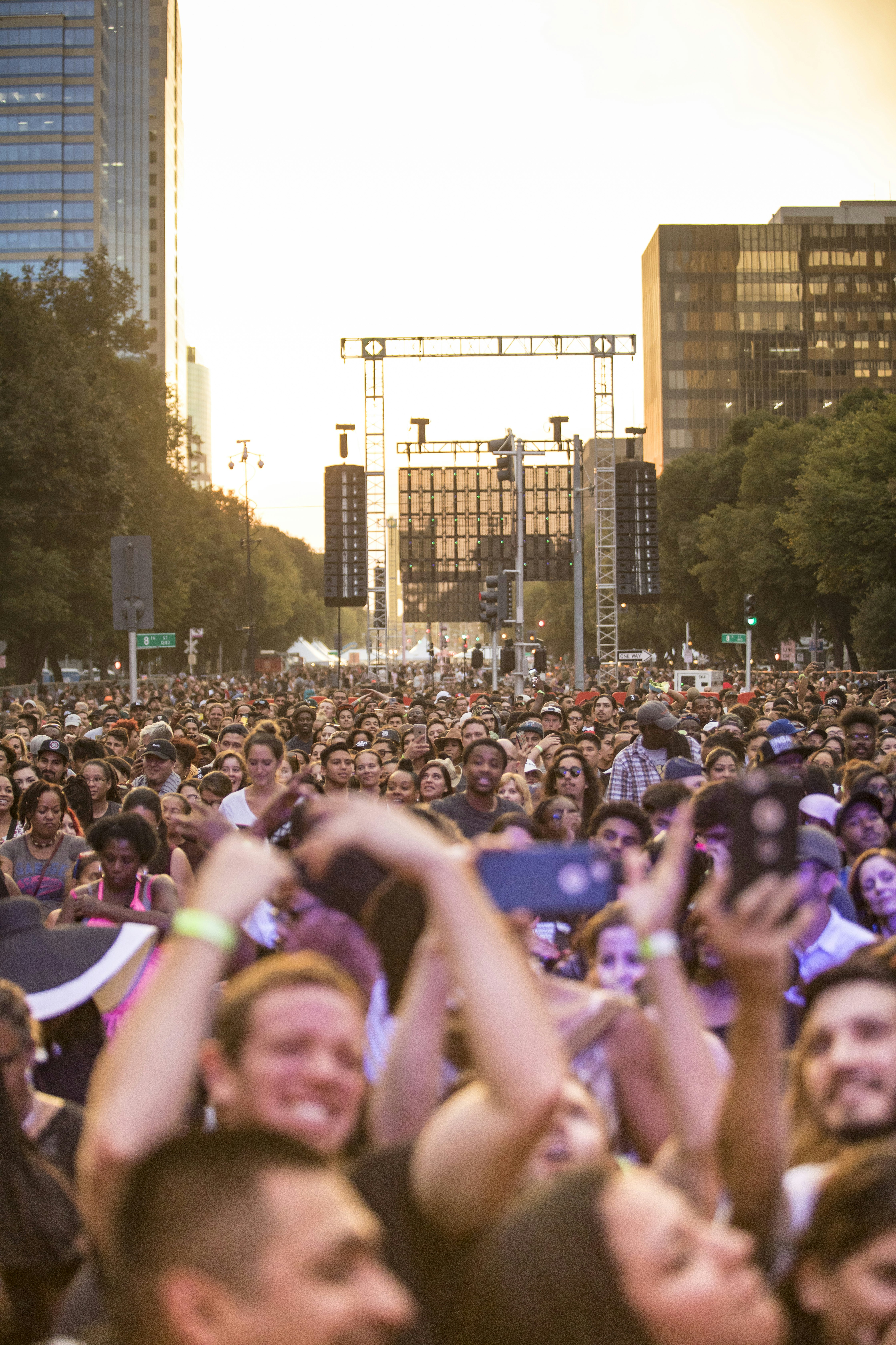 Crowd of people watching a live music festival stage.