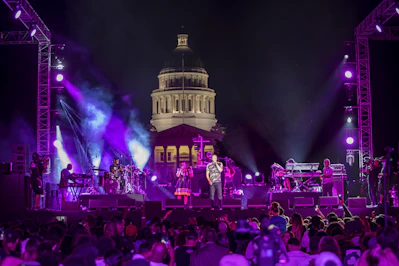 people gathering in front of white and blue building during nighttime