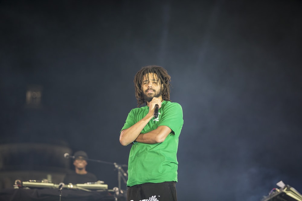 woman in green crew neck t-shirt singing