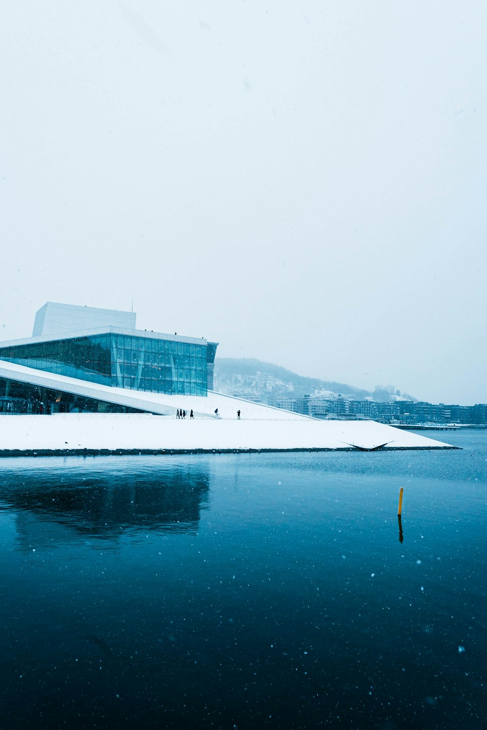 white building near body of water during daytime