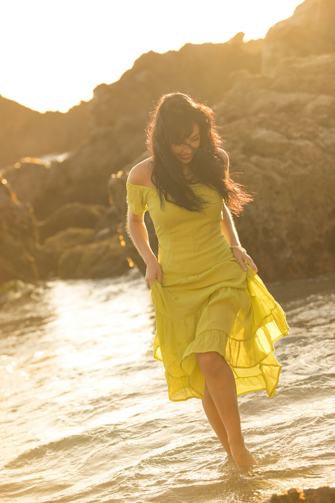 woman in yellow sleeveless dress standing on seashore during daytime